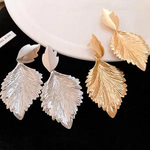 Elegant metallic leaf-shaped drop earrings with textured finish in gold and silver