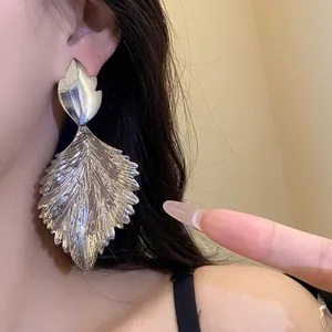 Fashionable silver metallic leaf drop statement earrings with textured pleated finish design