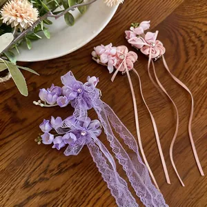 Sweet chiffon flower hair clips with lace tassels and rhinestones on wooden background