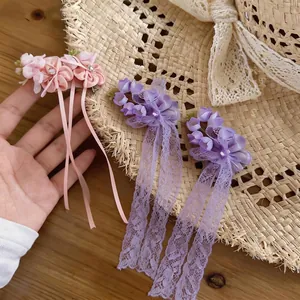 Chiffon flower hair clips with rhinestones and long lace tassels for a sweet look