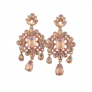 Vintage style flower earrings with peach crystal teardrop pendants on white background