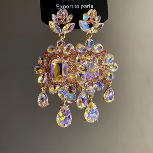 Macro detail view of vintage chandelier earrings featuring iridescent teardrop crystals