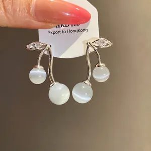 Elegant cat's eye stone and cubic zirconia drop earrings with silver needle, main view.
