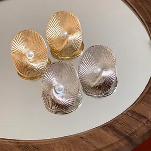 Elegant 18k gold plated oval textured stud earrings with a central pearl detail