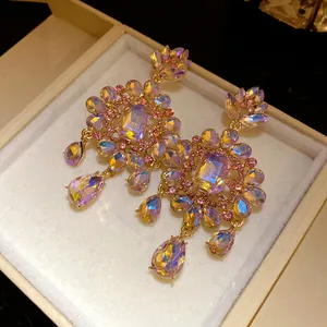Macro view of vintage flower earrings with iridescent crystals and teardrop pendants.