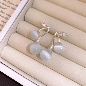 Elegant cherry-shaped earrings with cat's eye stone and zircon accents in jewelry box
