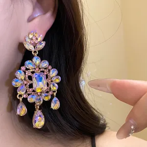 Close-up of vintage flower teardrop earrings with iridescent rhinestones in detail
