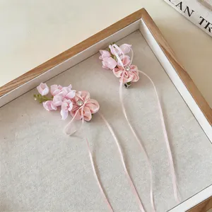 Elegant pink chiffon flower hair clips with sparkling rhinestones and long ribbon tassels.