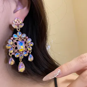 Close-up detail showing vintage flower earrings with iridescent teardrop rhinestones