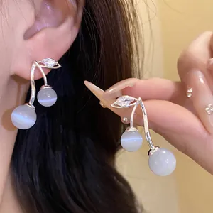Elegant cherry-shaped silver drop earrings featuring cat-eye stones and zircon details.