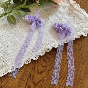 Pair of sweet purple chiffon flower hair clips with long lace tassels and rhinestones.
