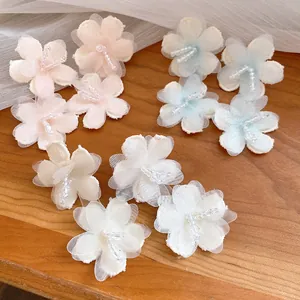 Detailed macro view of elegant mesh flower earrings with beaded centers for vacation