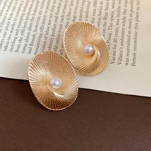 Elegant 18k gold plated oval textured stud earrings featuring a central pearl detail