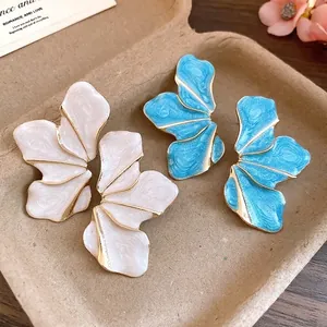 Elegant vintage floral stud earrings in white and blue enamel with gold-tone alloy accents