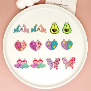 Various colorful cartoon DIY charms including hearts and butterflies on a white plate