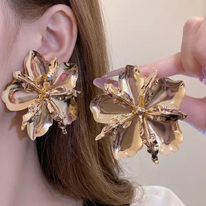 Large metallic gold flower stud earrings with a glossy vintage finish