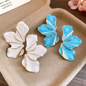 Detailed view of the textured petal surface and golden edges of these floral earrings.