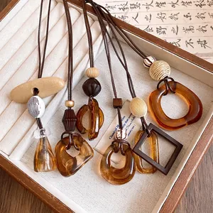 Vintage amber resin geometric pendant necklaces with adjustable leather cords in jewelry box