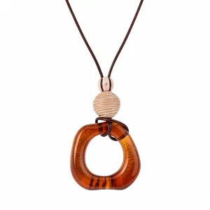 Bohemian style amber resin oval pendant necklace featuring brown leather cord and decorative beads
