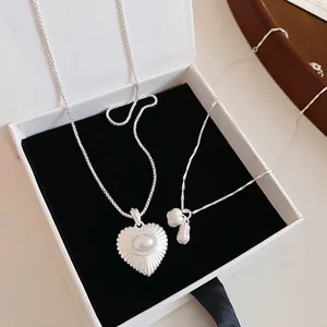 Elegant silver peanut and heart-shaped pearl pendant necklace set in a gift box
