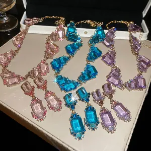 Detailed view of retro palace style geometric square necklaces and earrings in three colors.