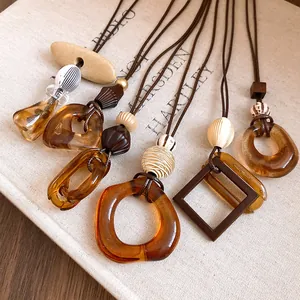 Close-up detail of stylish resin geometric pendant necklaces with faux leather cords.