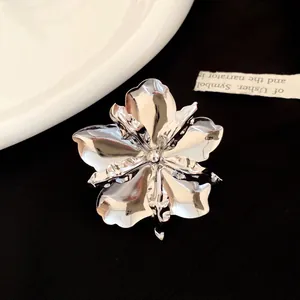 Detailed view of a metallic glossy flower ring with intricate petals