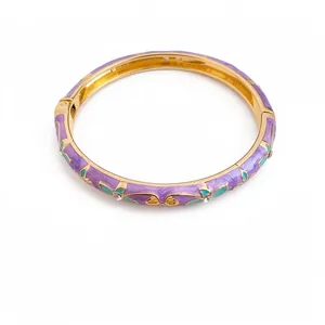 Elegant vintage gold-plated bangle featuring purple enamel flowers and crystal accents