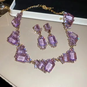 Detailed close-up of a vintage court style purple crystal necklace and earring set
