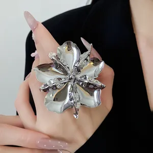 Exaggerated polished silver metal flower ring for women showing 3D petal details