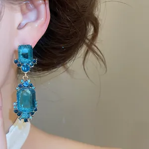 Vintage palace style drop earrings with blue geometric crystals and intricate details.