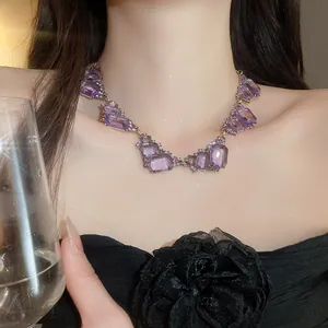 Close-up view of vintage geometric necklace with purple square crystals on model neck.