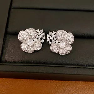 Elegant silver-toned floral stud earrings encrusted with sparkling cubic zirconia