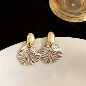 Elegant gold textured leaf stud earrings with silver needles for women luxury