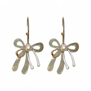 Elegant silver needle bow earrings with pearls and iridescent pastel ribbon detail