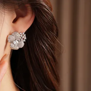 Close-up of elegant floral silver stud earrings encrusted with sparkling cubic zirconia