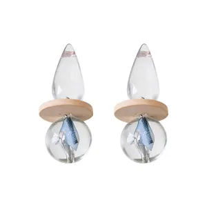 Vintage transparent teardrop earrings featuring wooden disc and blue starry sphere