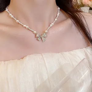 Elegant pearl necklace with a sparkling zircon bow pendant for a refined look.