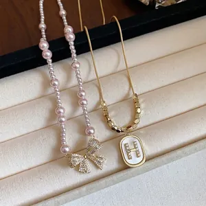 Elegant pearl and zircon necklace set featuring bow and 'H' letter pendants for women