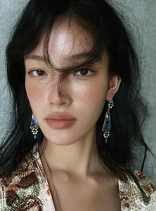Close-up detail of vintage palace-style floral resin drop earrings with crystals.