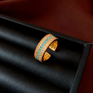 Detailed macro close-up of a vintage gold-plated ring set with turquoise beads and zircons