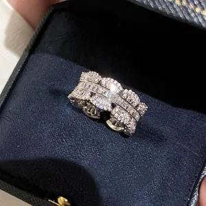 Elegant silver zircon multi-layer ring featuring baguette and round stones in a jewelry box