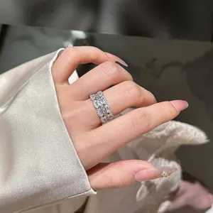 Elegant silver finish zircon ring for women on index finger, minimalist luxury style.