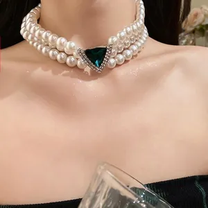 Vintage three-layer pearl choker necklace with a stunning green triangle pendant