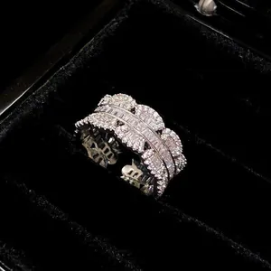 Elegant wide band cubic zirconia ring with sparkling stones in a black velvet jewelry box