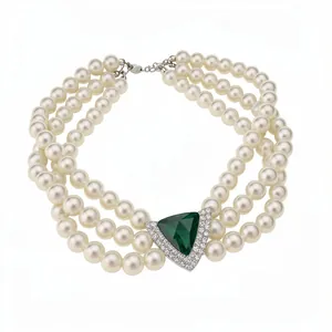 Elegant vintage three-strand pearl choker necklace with a triangular emerald green gemstone