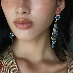 Close-up detail of vintage style resin flower earrings with blue accents on model