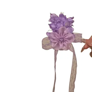 Elegant purple chiffon flower hair clip featuring sparkling rhinestones and lace ribbons