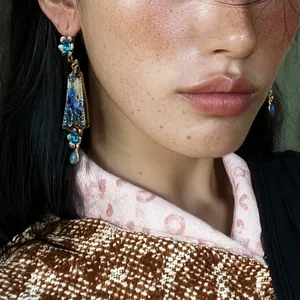 Exquisite close-up of vintage blue floral drop earrings with rhinestones on a model