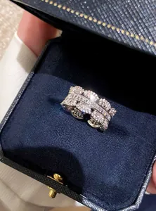 Close-up view of an elegant silver zircon ring displayed inside a luxury blue jewelry box